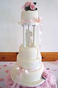 Pink wedding cake on pillars